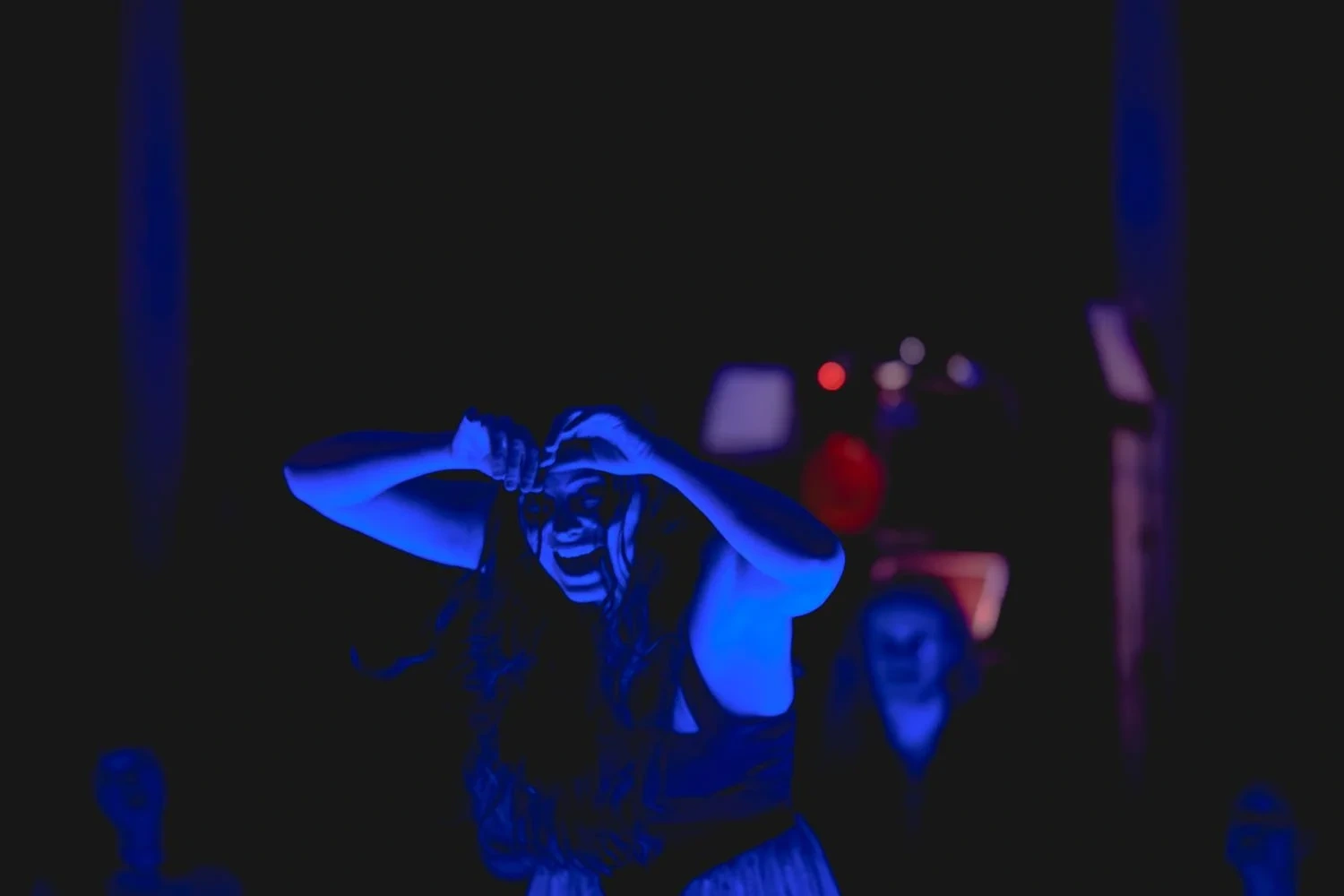 A dancer lit in blue at Psychomagic 9.